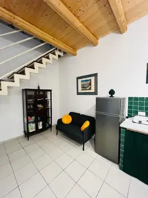 a living room with a couch and a kitchen at Mia Domus in Palermo