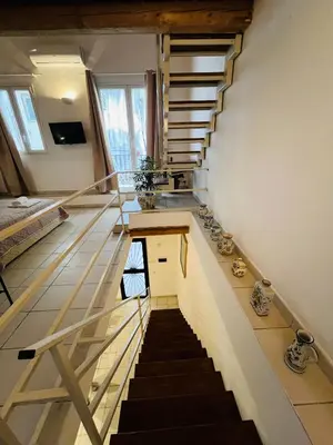 a winding staircase in a house with a stair case at Mia Domus in Palermo