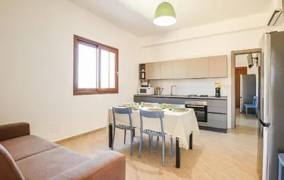 a kitchen and dining room with a table and chairs at Nice Home In Balestrate in Balestrate