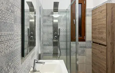 a bathroom with a sink and a glass shower at Nice Home In Balestrate in Balestrate