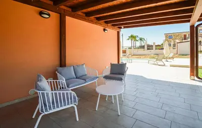 a patio with chairs and a table and a table and chairs at Nice Home In Balestrate in Balestrate