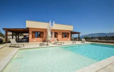 a villa with a swimming pool in front of a house at Nice Home In Balestrate in Balestrate