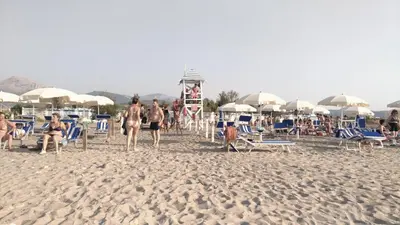 a group of people playing volleyball on the beach at Campeggio Praia Mare in Campofelice di Roccella
