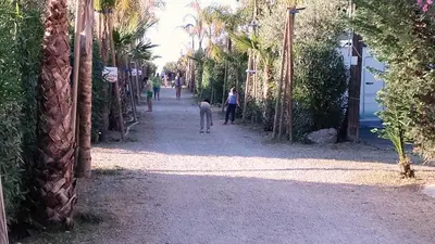 a crowd of people on a beach with umbrellas at Campeggio Praia Mare in Campofelice di Roccella