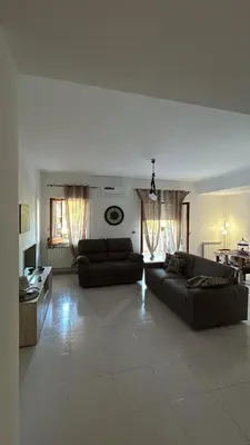 a living room with two couches and a table at La casa dei Nonni in Santa Flavia