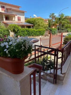 a balcony with a bench and a potted plant at La casa dei Nonni in Santa Flavia