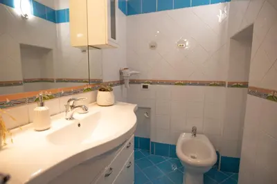 a bathroom with a sink and a toilet at Re Tancredi Apartment in Palermo