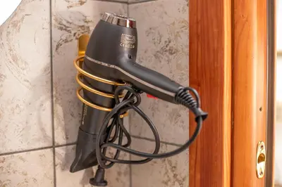 a hair dryer is hanging on a wall at Re Tancredi Apartment in Palermo