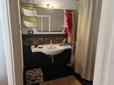 a bathroom with a sink and a mirror at House Vintage Charme by Holiday World in Palermo