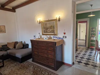 a living room with a couch and a wooden dresser at House Vintage Charme by Holiday World in Palermo