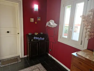 a room with a red wall with a cowboy hat on the wall at House Vintage Charme by Holiday World in Palermo