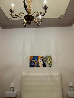 a chandelier hanging from a ceiling in a room at IG Holiday in Cinisi