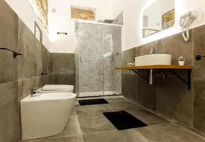 a bathroom with a toilet and a sink and a shower at IG Holiday in Cinisi