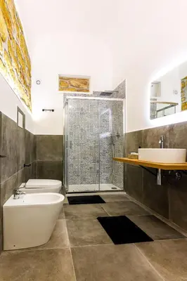a bathroom with a shower and a toilet and a sink at IG Holiday in Cinisi