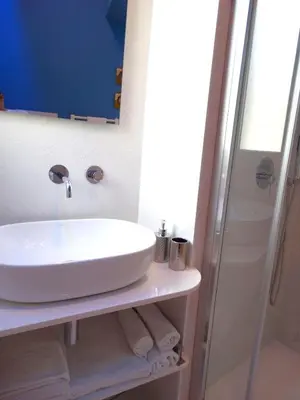 a bathroom with a sink and a shower at La Maschera di Giano, case vacanza vista mare in Palermo