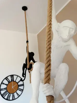 a statue of a monkey hanging from a ceiling at La Maschera di Giano, case vacanza vista mare in Palermo