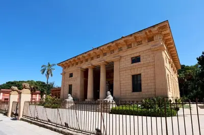 a building with a fence in front of it at Ivi's House in Palermo