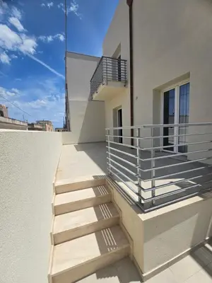 a set of stairs on the side of a building at Alle Porte di San Vito in San Vito lo Capo