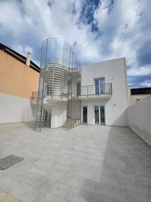 a building with a spiral staircase on top of it at Alle Porte di San Vito in San Vito lo Capo