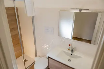 a bathroom with a sink and a shower and a toilet at Casa Donna Ina in Palermo
