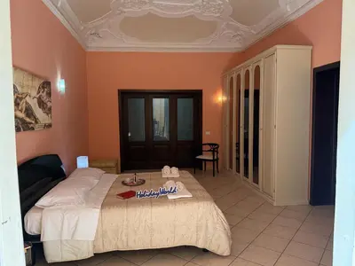 a bedroom with a bed with a table in it at Nuovo Basile by Holiday World in Palermo