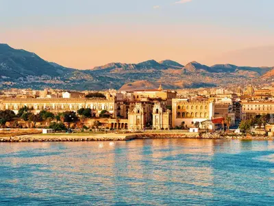a city on the water with mountains in the background at Nuovo Basile by Holiday World in Palermo
