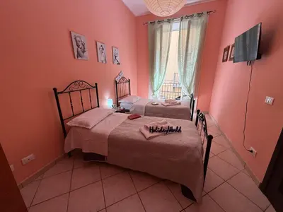 two beds in a room with pink walls at Nuovo Basile by Holiday World in Palermo