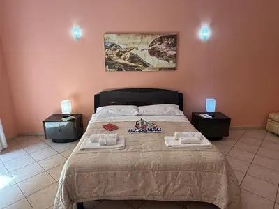 a bedroom with a bed with two towels on it at Nuovo Basile by Holiday World in Palermo