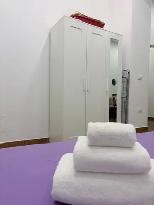 a white bathroom with a toilet and a sink at Violet House in Palermo