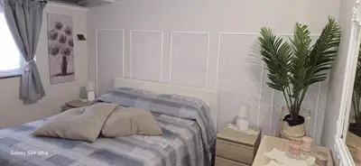 a bedroom with a bed and a potted plant at la casetta di nin e gian mondello in Palermo