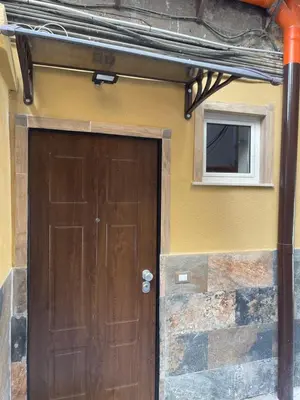 a building with an arch with statues on it at La casetta del sole in Palermo