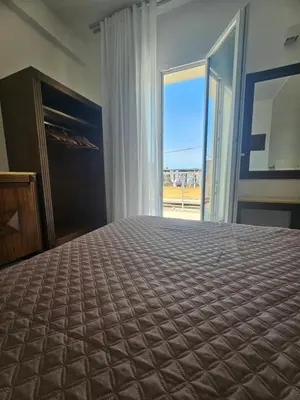a bedroom with a large bed and a large window at Alle Porte di San Vito 2 in San Vito lo Capo