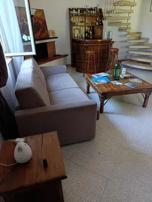 a bedroom with a bed and two chairs and a table at House in Garden in Palermo