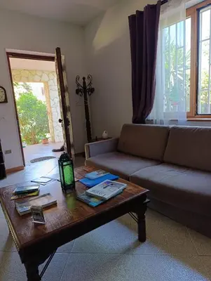 a living room with a couch and a coffee table at House in Garden in Palermo