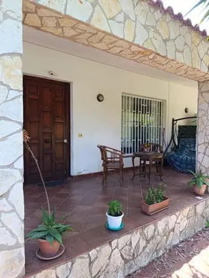 an open door to a patio with a table at House in Garden in Palermo