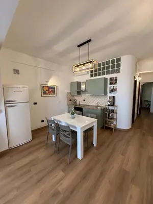 a kitchen and dining room with a white table and chairs at La Casetta Panoramica in Palermo