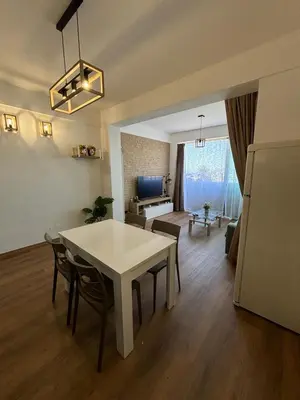 a kitchen and living room with a table and chairs at La Casetta Panoramica in Palermo