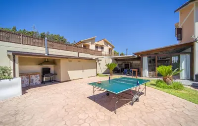 a ping pong table in the backyard of a house at Gorgeous Home In Trabia in Trabia