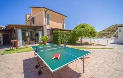 a ping pong table in front of a house at Gorgeous Home In Trabia in Trabia