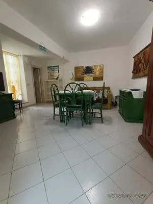a dining room with green chairs and a table at Villino Sirene Mondello in Palermo