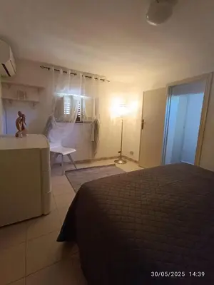 a bedroom with a bed and a table and a lamp at Villino Sirene Mondello in Palermo