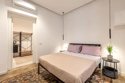 a bedroom with a bed with purple pillows at Ai Vicoli Ciambra's Alley by Wonderful Italy in Monreale