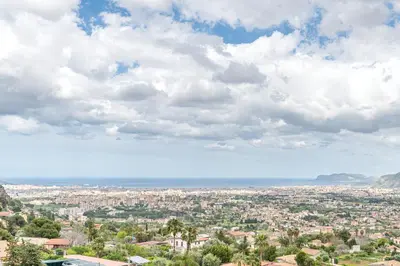 a view of a city under a cloudy sky at Ai Vicoli Ciambra's Alley by Wonderful Italy in Monreale