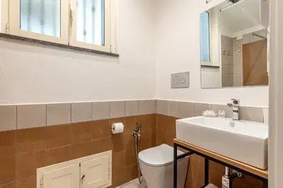 a bathroom with a white toilet and a sink at Ai Vicoli Ciambra's Alley by Wonderful Italy in Monreale