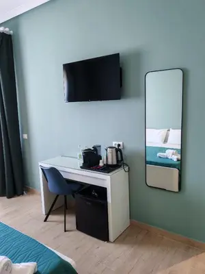 a room with a desk and a mirror and a bed at MARE Suite in Palermo