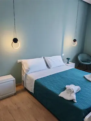 a bedroom with a bed with towels on it at MARE Suite in Palermo