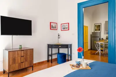 a living room with a flat screen tv and a table at Elegant Two-Room Apartment with Balcony & Suite in Palermo
