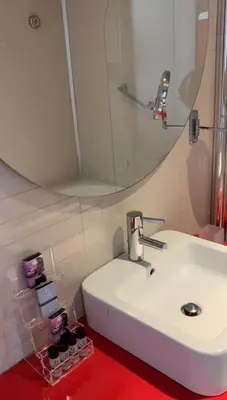 a bathroom with a white sink and a mirror at Domina Zagarella multiproprietà MINIMO 6 NOTTI in Santa Flavia