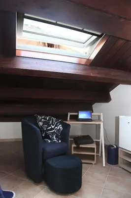 a room with a chair and a skylight at Centro storico apartment & Loft - Amnesia Holiday Home in Palermo