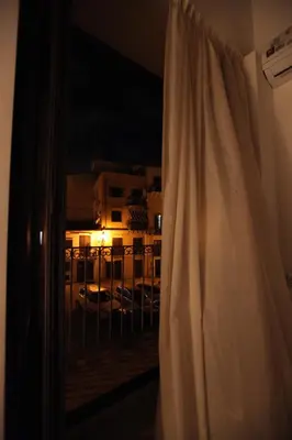 a window with a view of a city at night at Centro storico apartment & Loft - Amnesia Holiday Home in Palermo